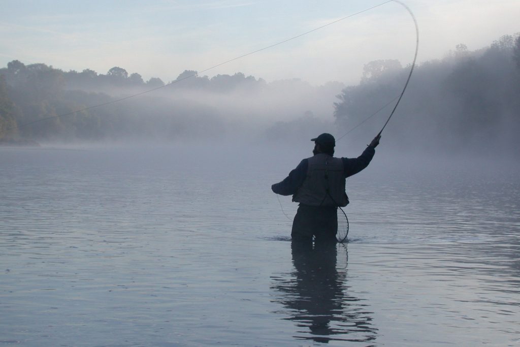 Person fishing in the Grand River in Paris