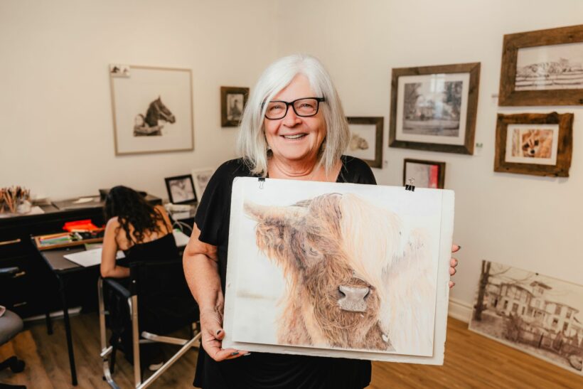 Artist at the Williams Mill Creative Studios showing off her art
