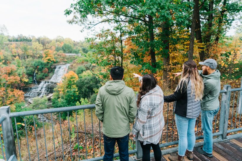 Couples looking at Albion Falls in the fall