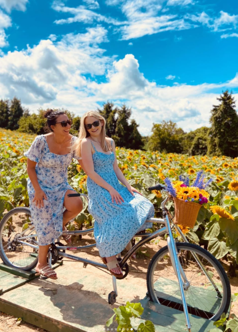 A mother and daughter enjoying the sunflowers at Brantwood Farms